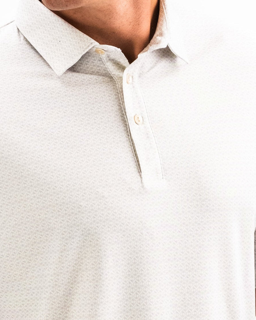 Close-up of a person wearing a white Player Preferred™ Polo - Vapor Spade with a subtle textured pattern and buttoned collar.