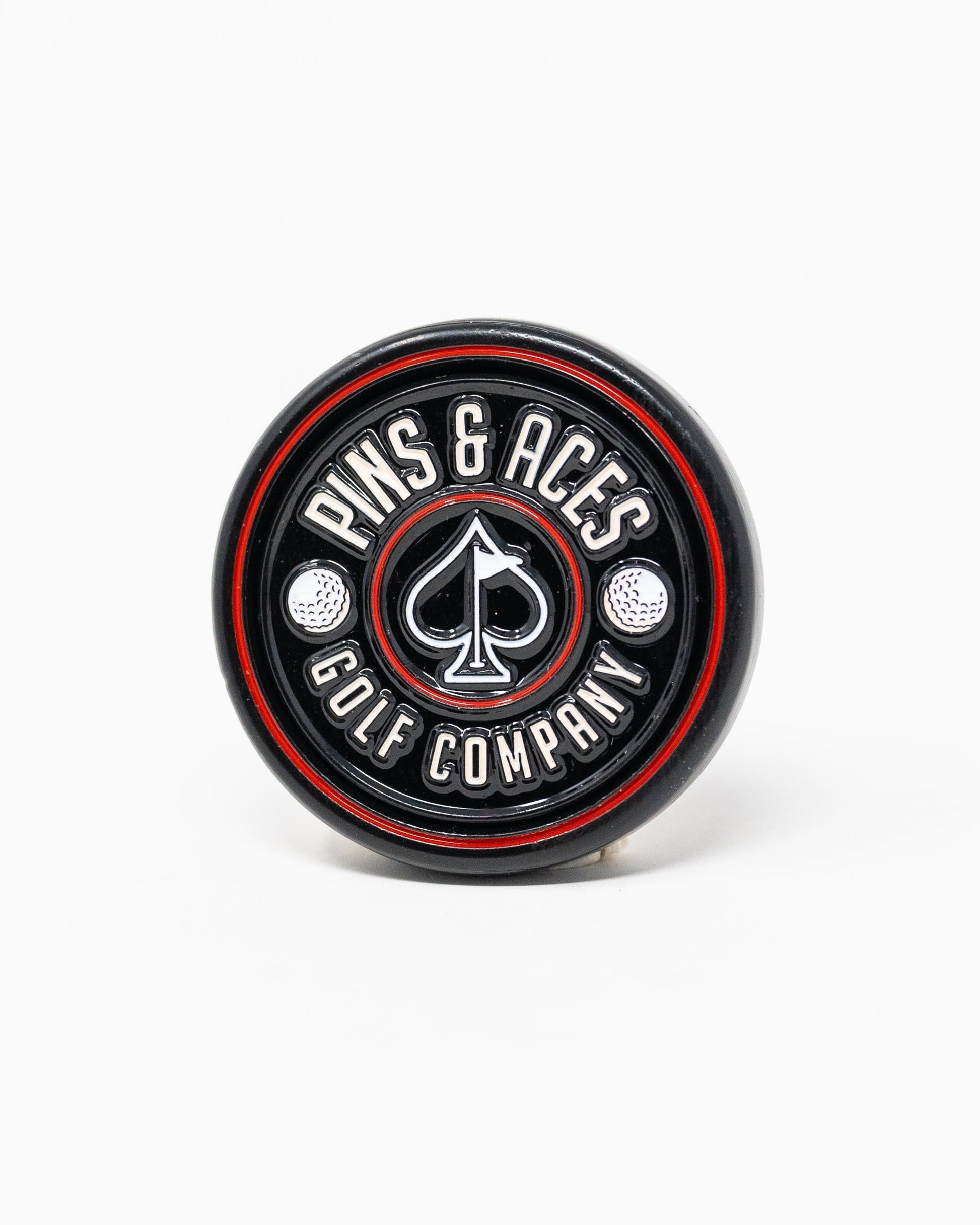 Black Pop Out Medallion Ball Marker, showcasing a sleek design and compact size for easy use on the golf course.