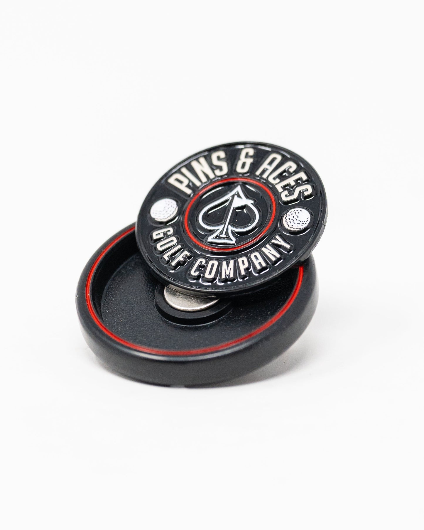 Black Pop Out Medallion Ball Marker, featuring a sleek design and compact size for easy use on the golf course.