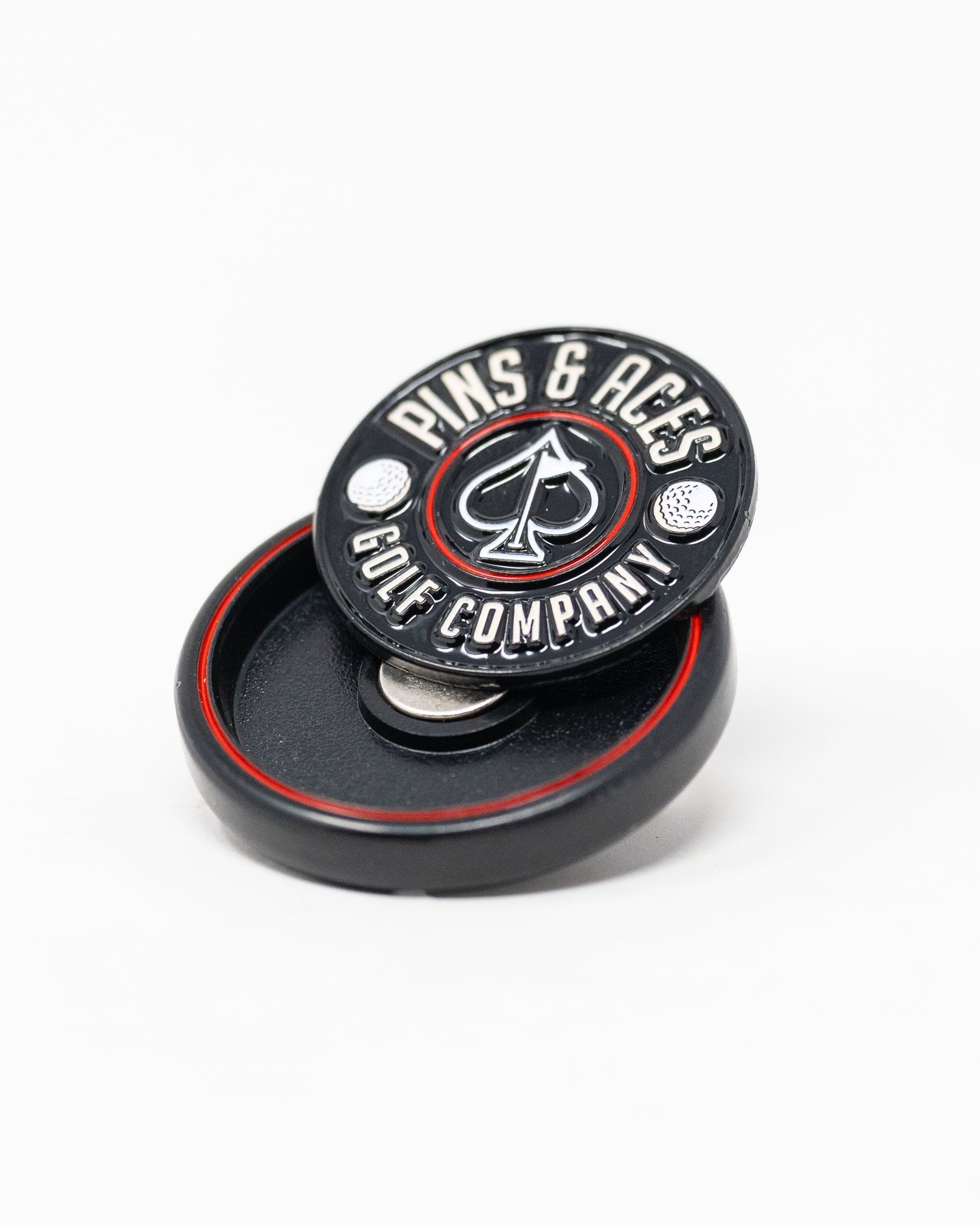 Black Pop Out Medallion Ball Marker, featuring a sleek design and compact size for easy use on the golf course.