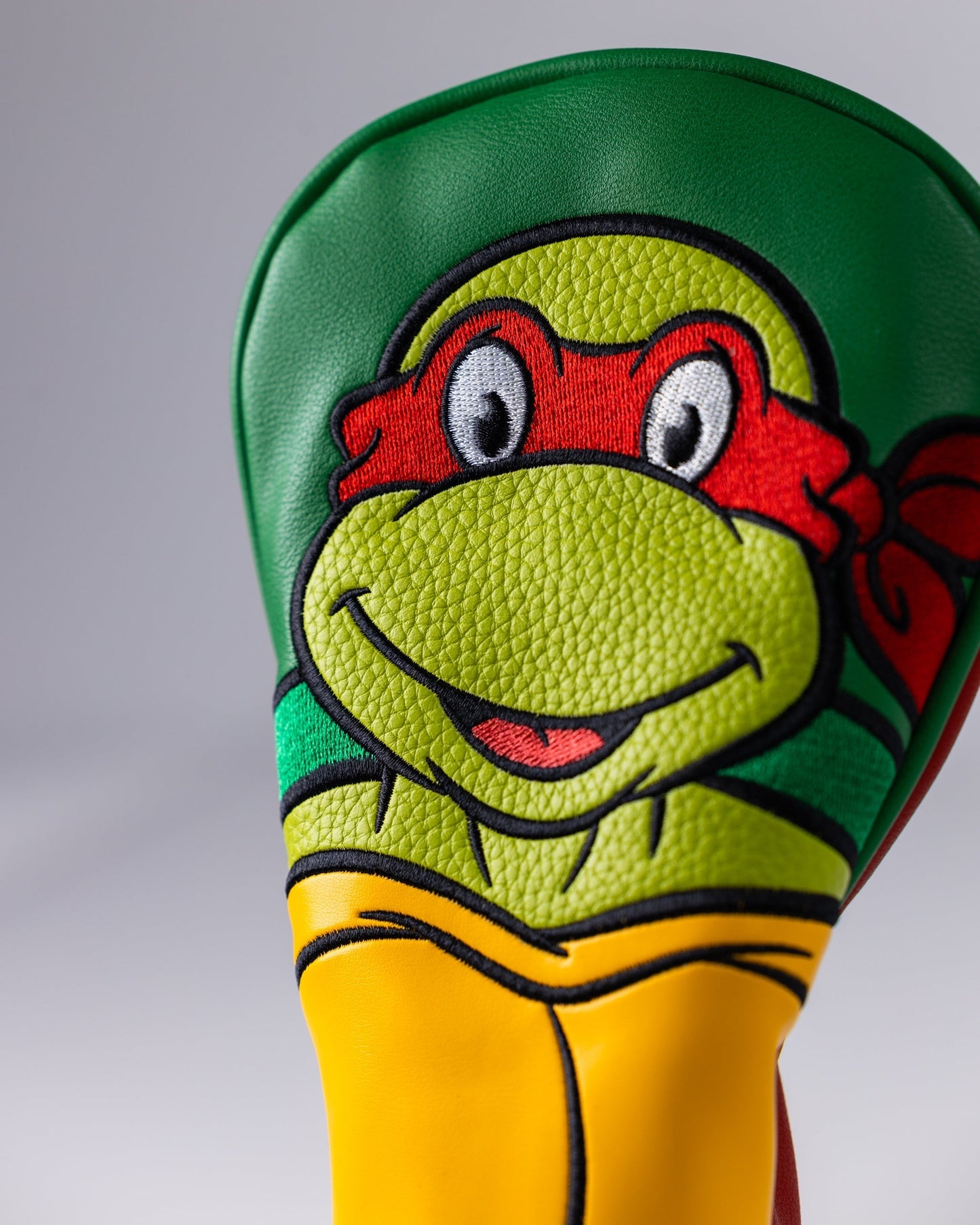 TMNT Raphael hybrid golf club cover featuring a vibrant design with Raphael's iconic mask and colors.