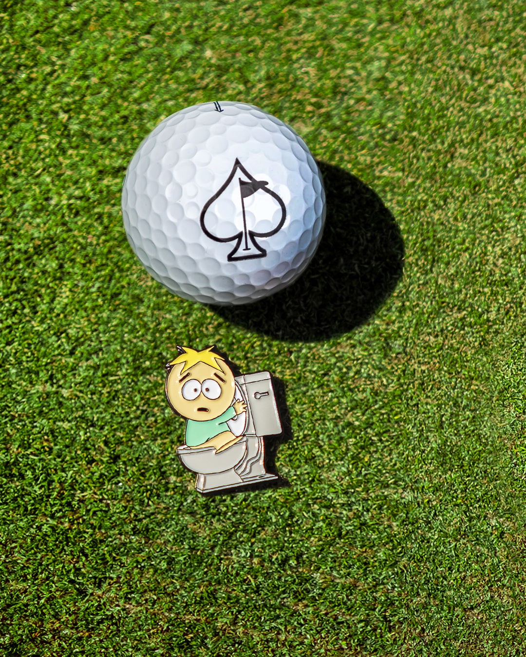 South Park Butters ball marker on a golf tee, featuring a colorful design of the character in a playful pose.