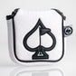 White golf headcover with embossed spade pattern, black embroidered spade logo, black trim, and a small black and white "P...