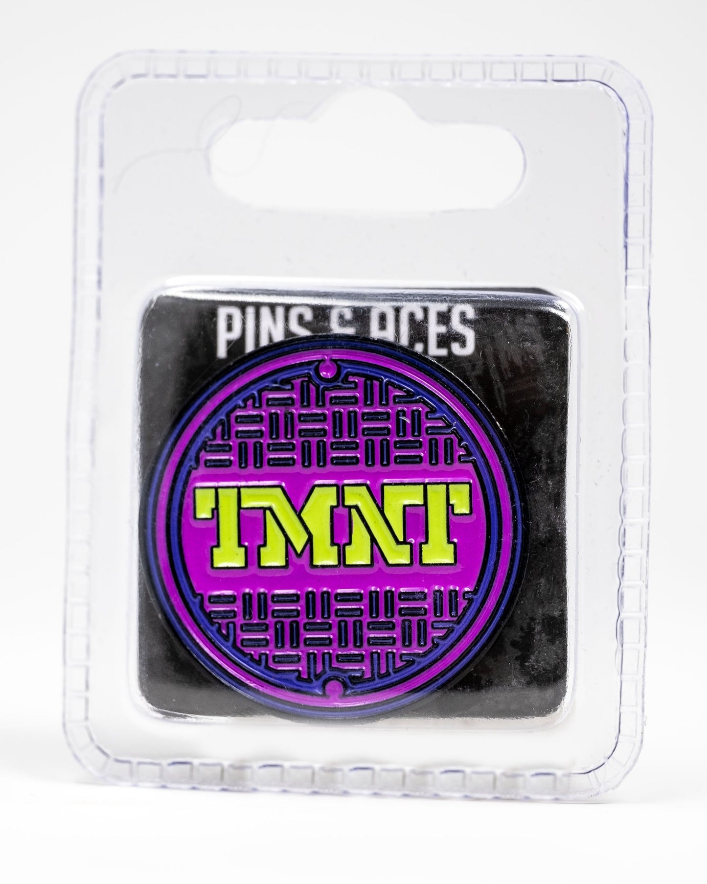 TMNT Sewer Cover Ball Marker featuring colorful Teenage Mutant Ninja Turtles design on a circular, metallic surface.