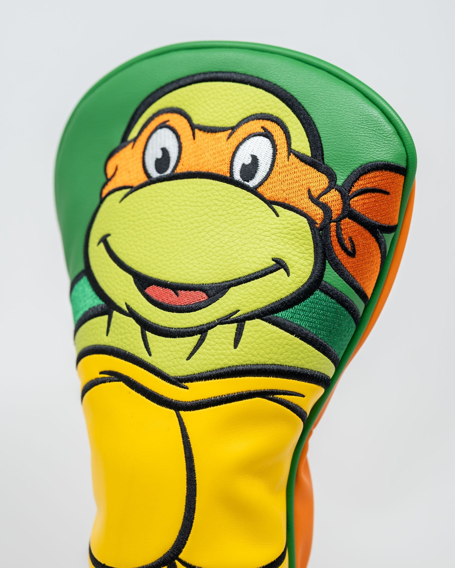 TMNT Michelangelo driver cover featuring vibrant orange and green colors with character design, ideal for golf enthusiasts and Teenage Mutant Ninja Turtles fans.