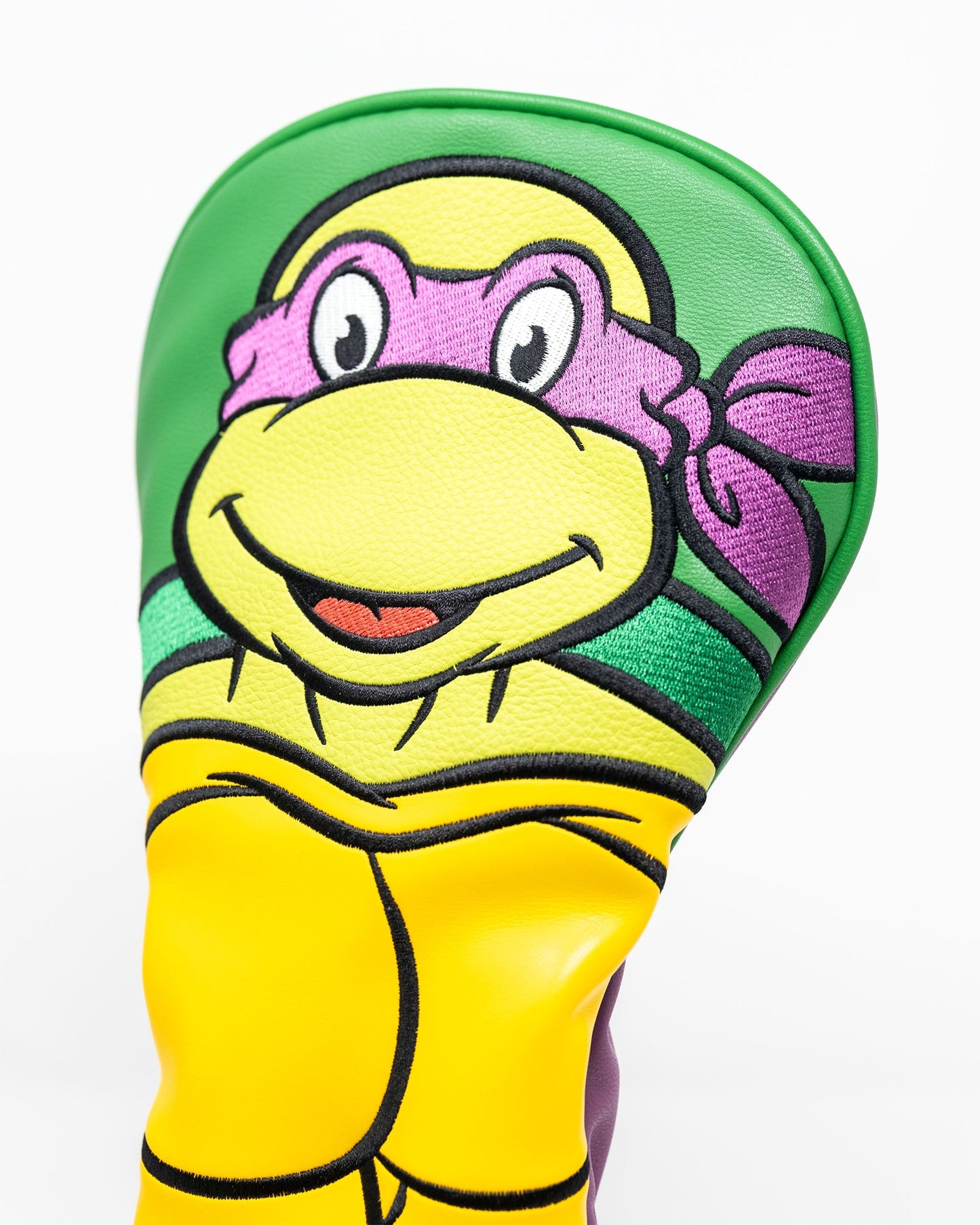 Alt text: "TMNT Donatello driver cover featuring a vibrant design of the character in purple with detailed facial features and a ninja mask."
