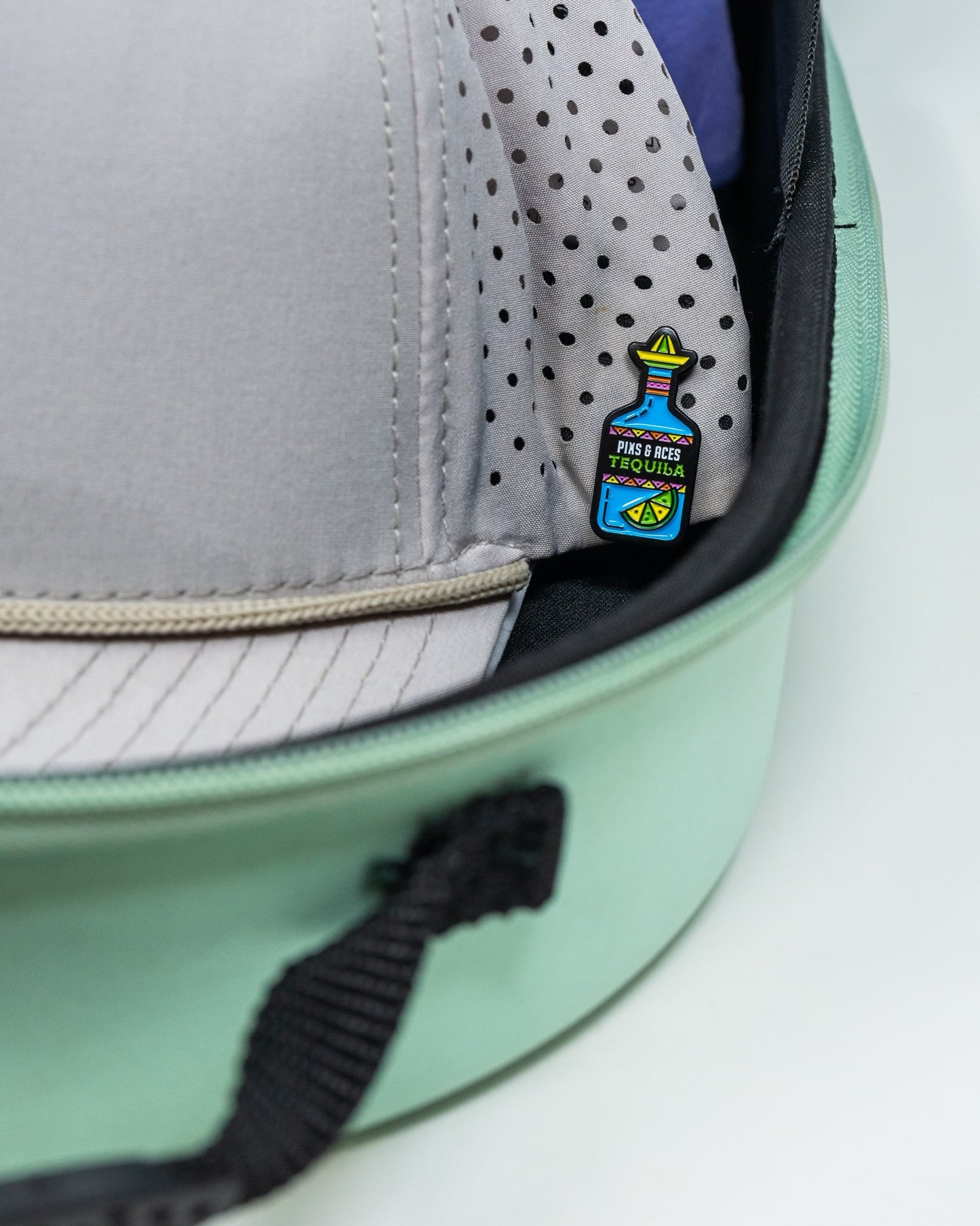 Teal Hat Caddie for organizing and displaying hats, featuring a curved design and sturdy base.