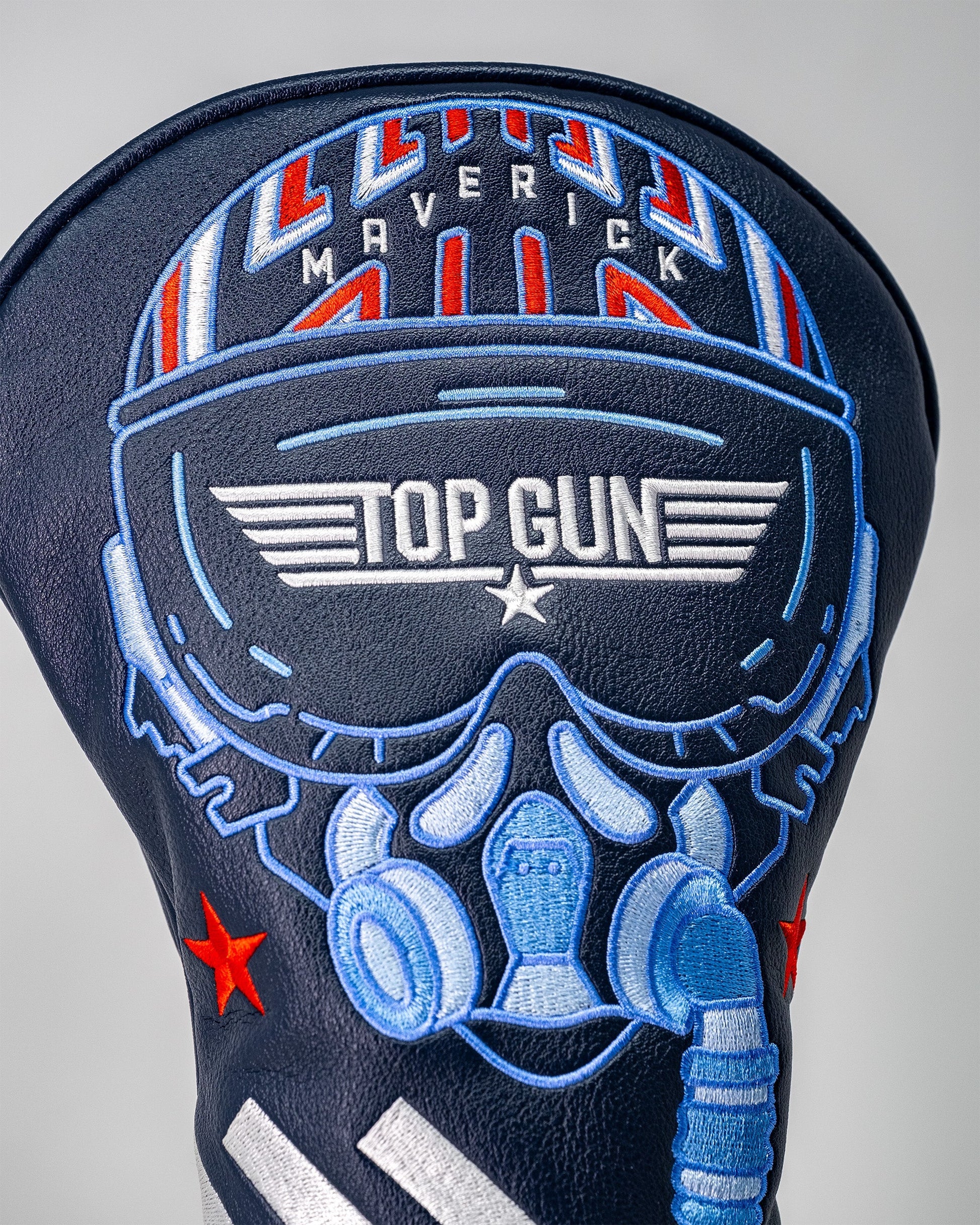 Embroidered Top Gun Maverick themed golf driver headcover featuring a skull wearing headphones, sunglasses, and a pilot helmet design.