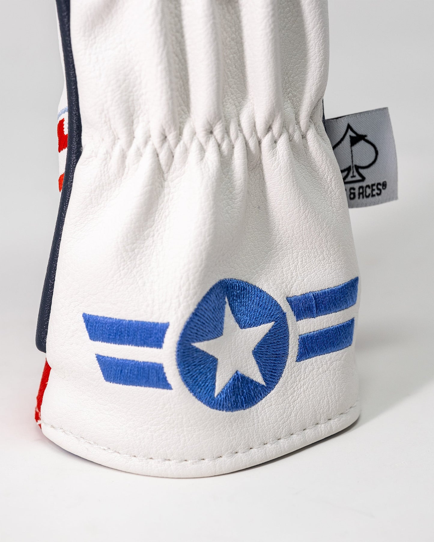 White golf headcover with blue embroidered star and stripes, featuring a Goose hybrid design from Top Gun collection.