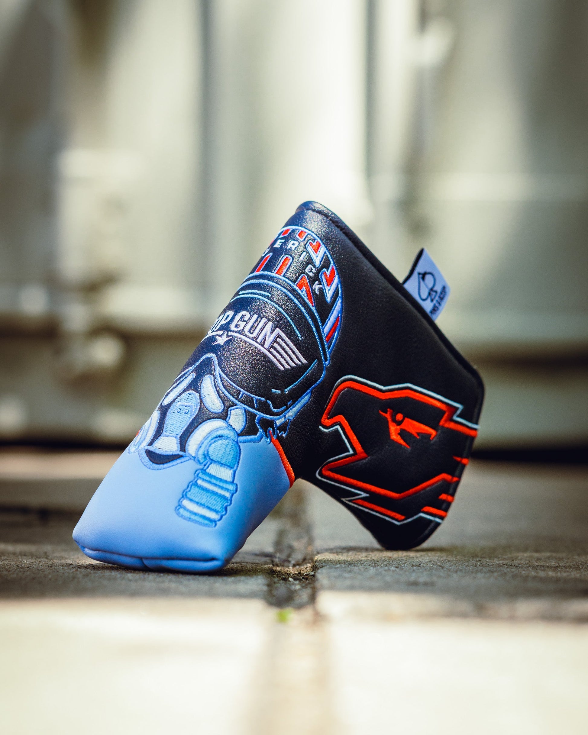 Top Gun Maverick Blade Headcover with embroidered aviation-themed patches in black, blue, and red, designed for golf clubs.