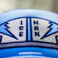 Close-up of the Top Gun Ice Man fairway headcover showing embroidered navy blue and beige patch with compass design and "Ice Man" text.