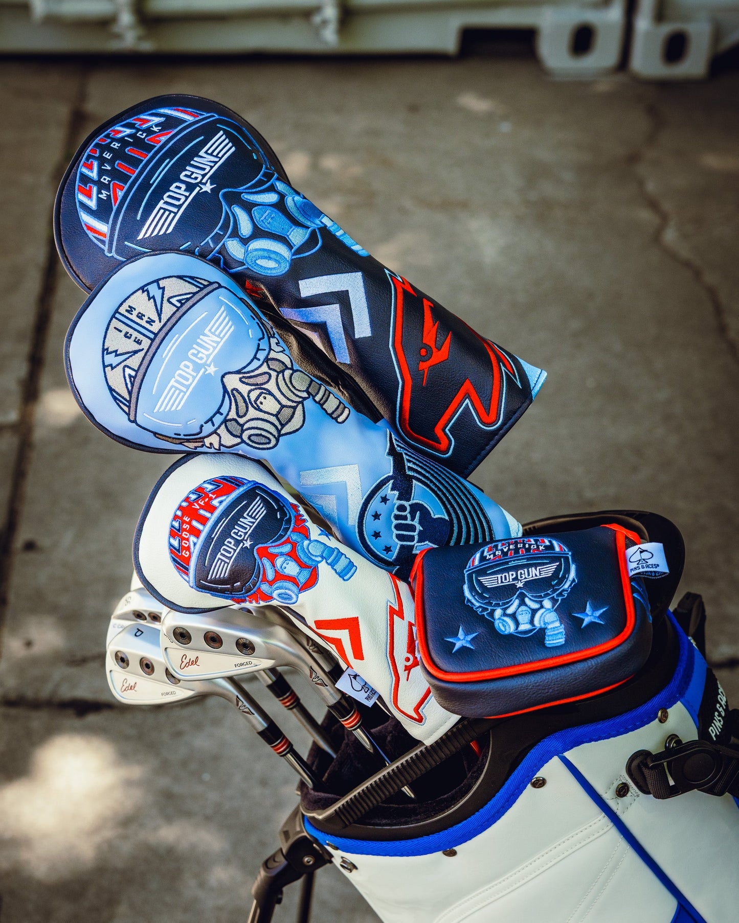 Top Gun Ice Man themed golf headcover set with military-inspired design and bold colors, placed in a golf bag with clubs.