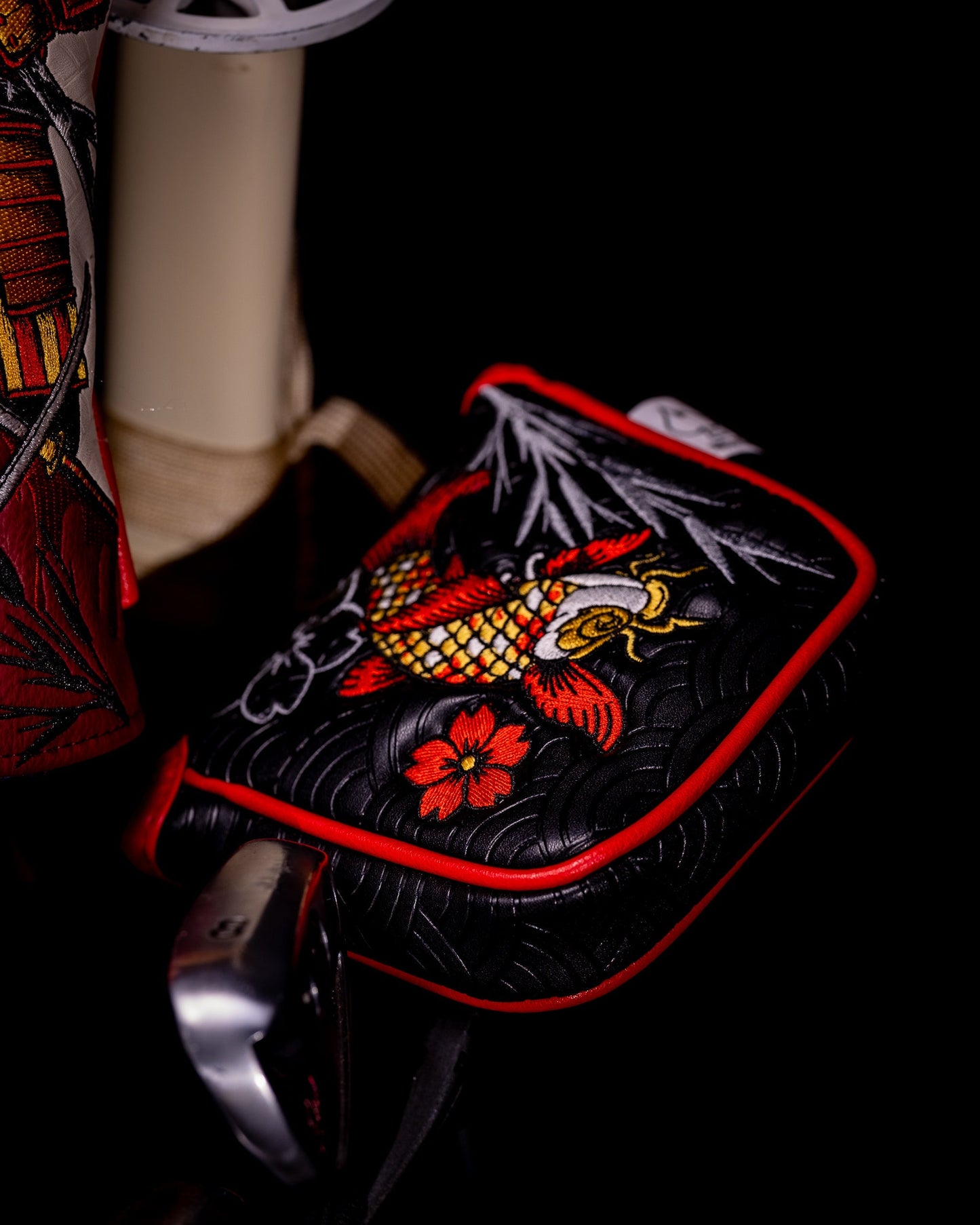 Koi Flow mallet putter cover featuring a vibrant koi fish design on a dark background.